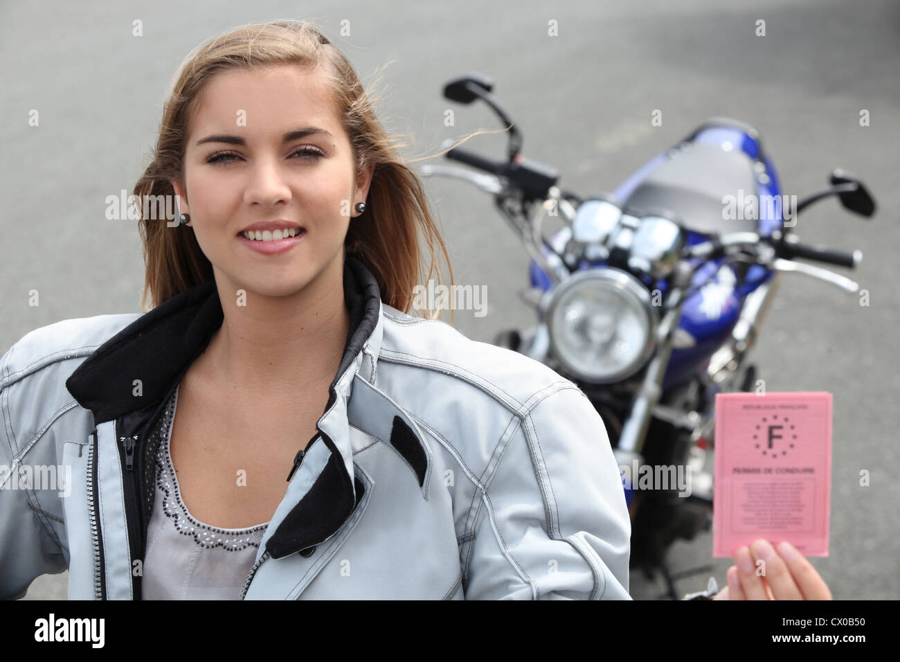 Woman with a motorbike and driver's license Stock Photo