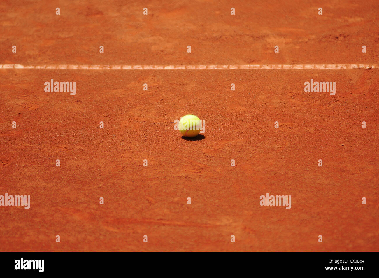 Tennis ball on clay court, daytime Stock Photo Alamy