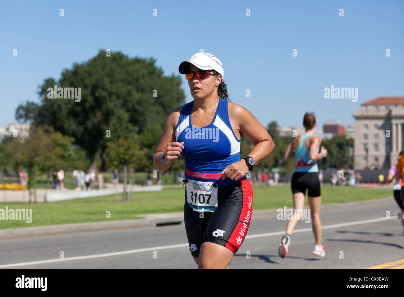 Female racer running in a marathon Stock Photo