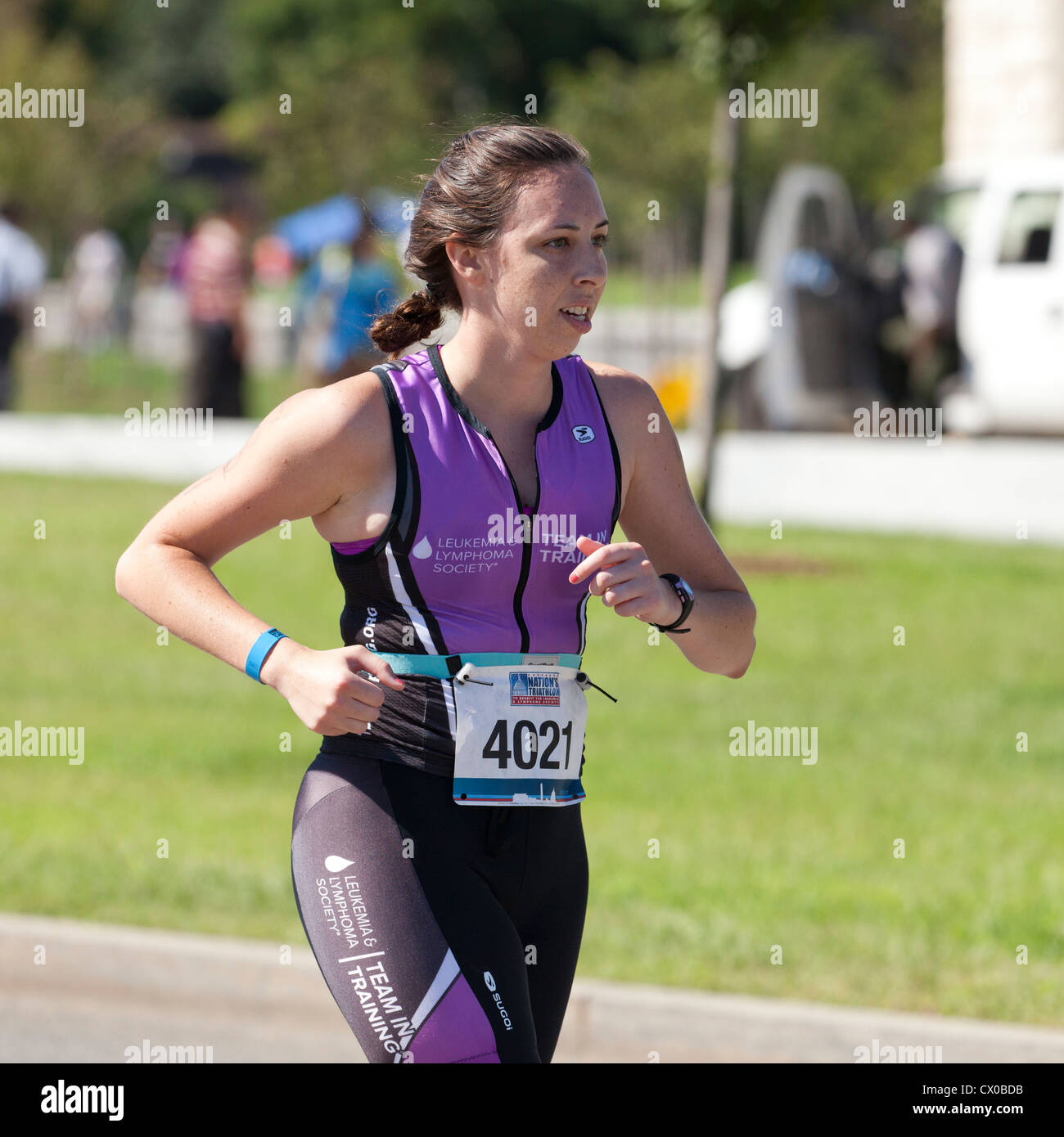 Female racer running in a marathon - USA Stock Photo