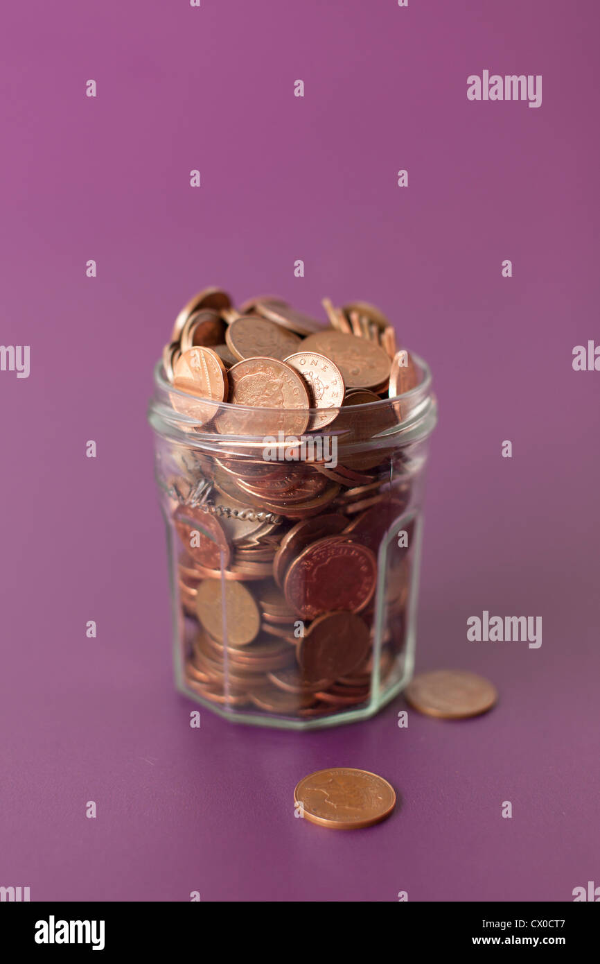 Jar full with pennies Stock Photo