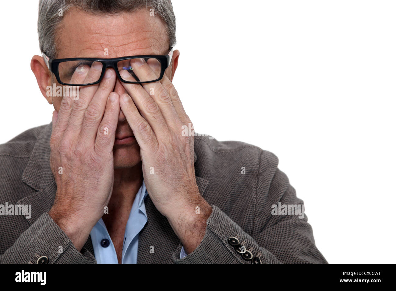 Man rubbing his eyes Stock Photo