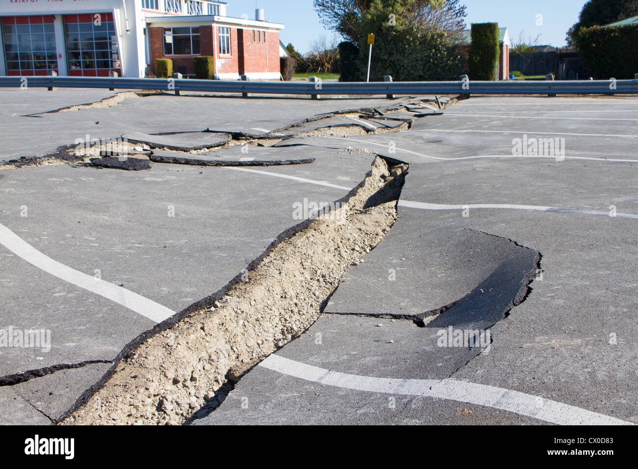 Earthquake shock-waves have caused this carpark to crack open and slump. Stock Photo