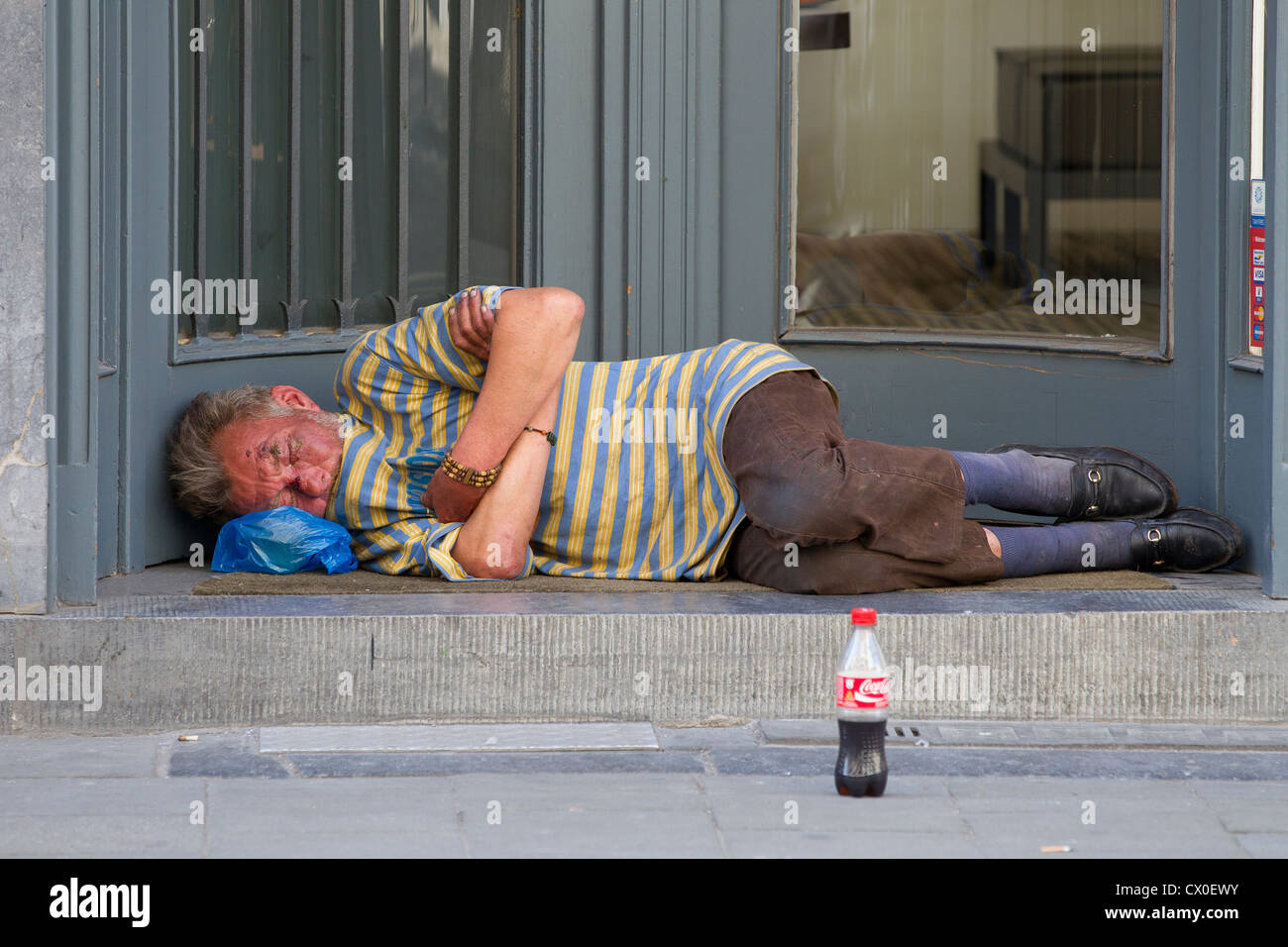 homeless man sleeping doorway Stock Photo