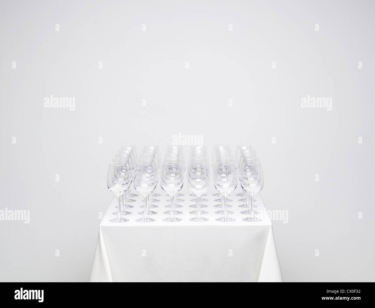 Rows of empty wine glasses on a table. Similar photo available with one glass full. Stock Photo