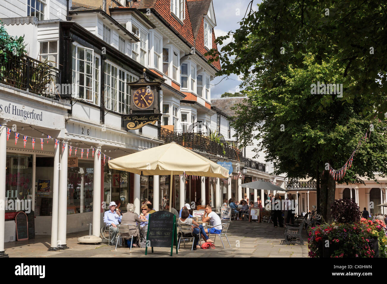 Street scene with people dining outside a cafe with Georgian colonnades. The Pantiles Royal Tunbridge Wells Kent England UK Stock Photo