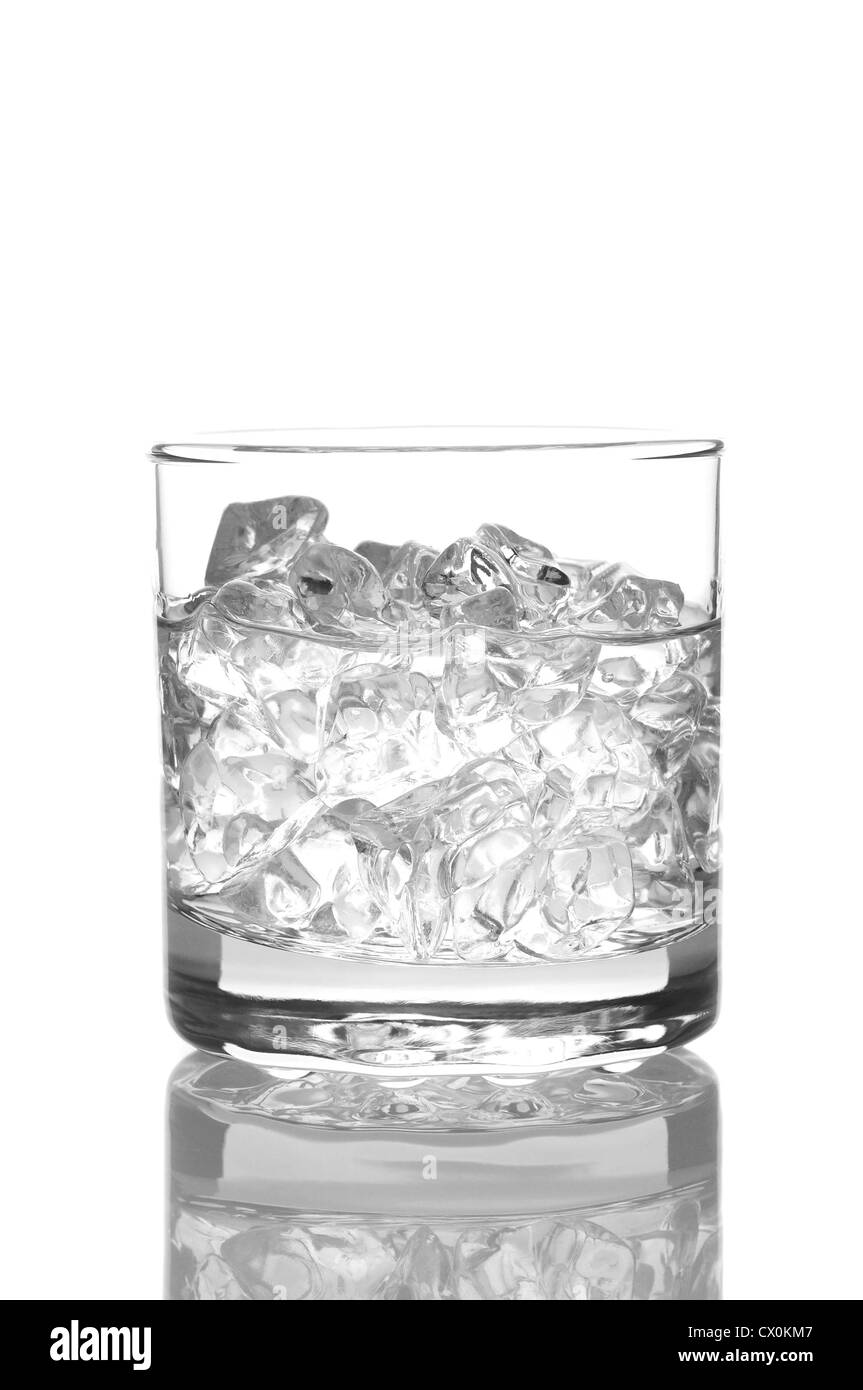 Close up of a glass of water or vodka with ice cubes. Vertical Format isolated on white with reflection. Stock Photo
