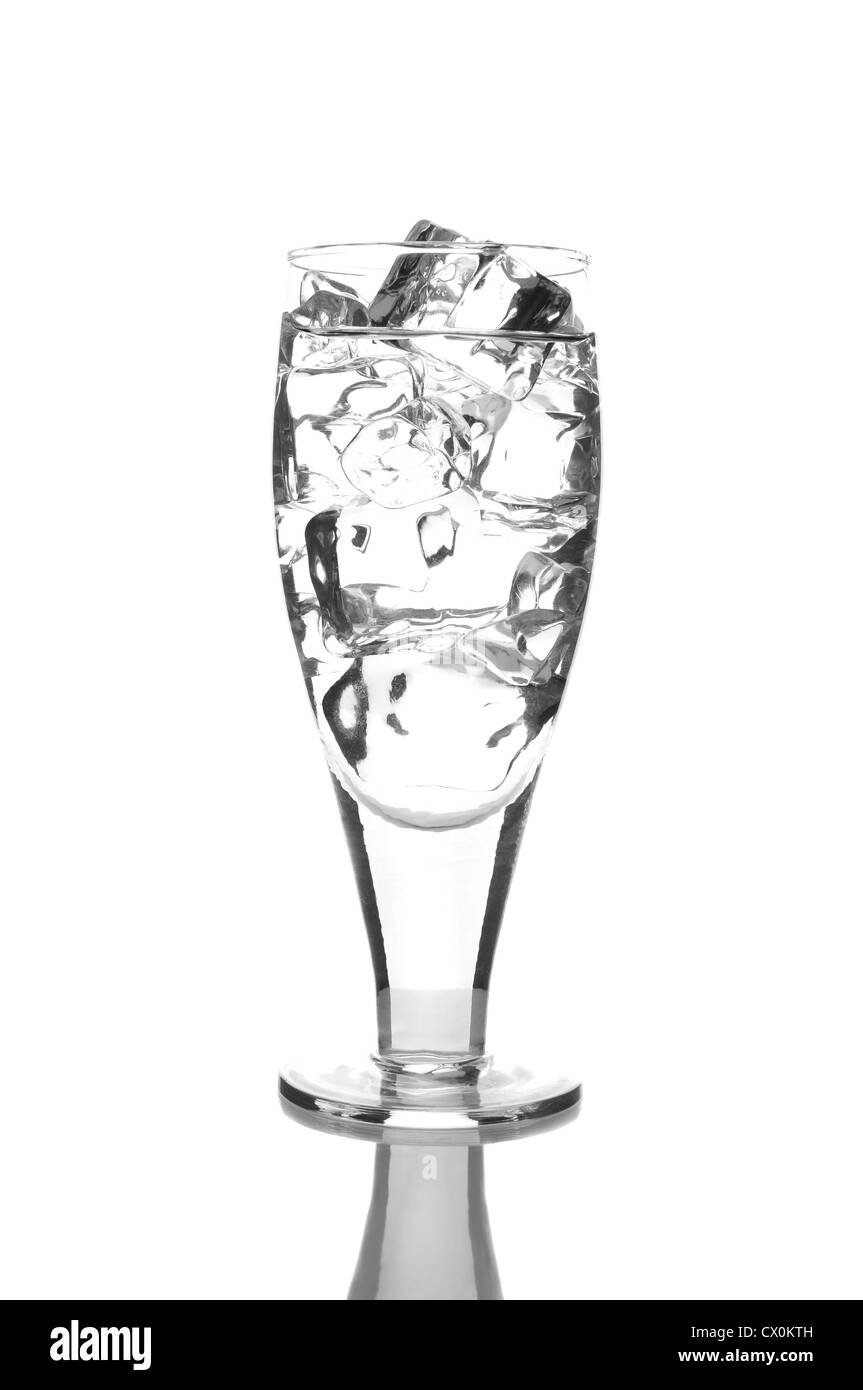 Close up of a glass of water or vodka with ice cubes. Vertical Format isolated on white with reflection. Stock Photo