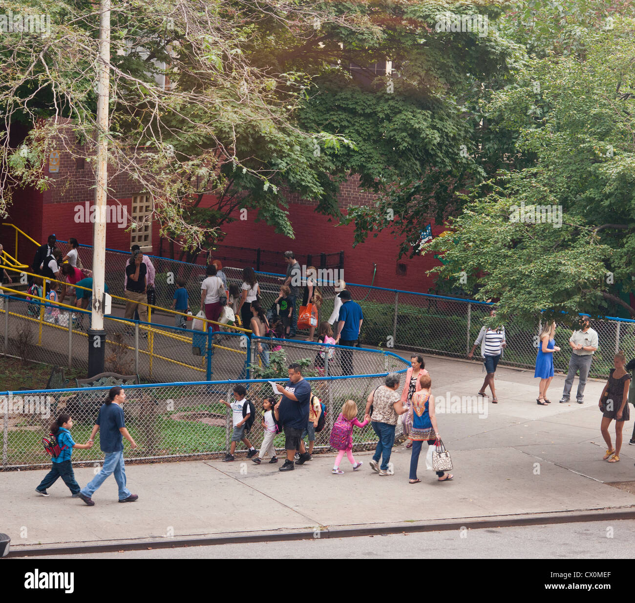 Parents and children arrive at a school in the New York neighborhood of Chelsea for the first day of class Stock Photo