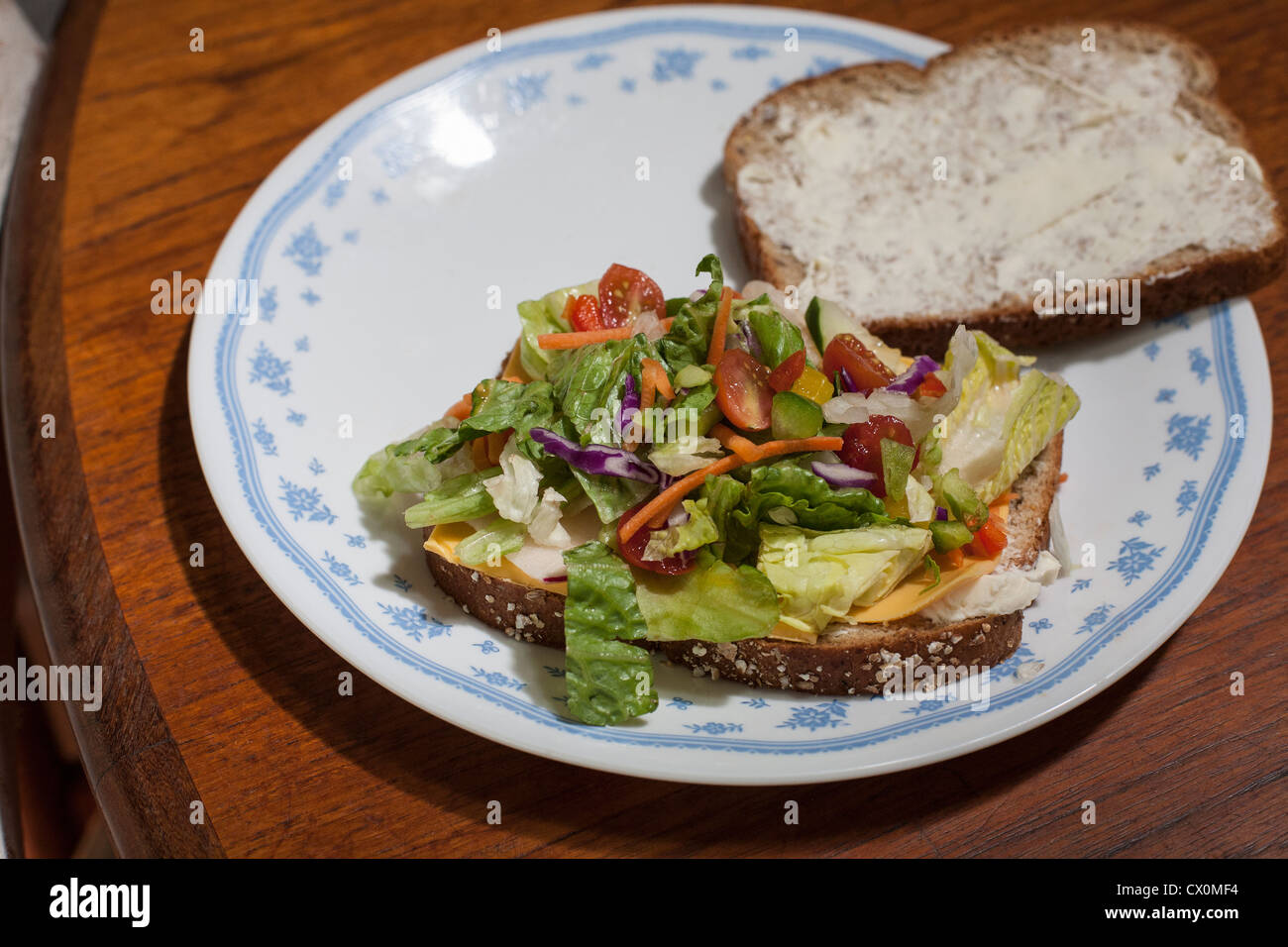 A healthy sandwich made with whole wheat bread, cheese and salad ingredients Stock Photo