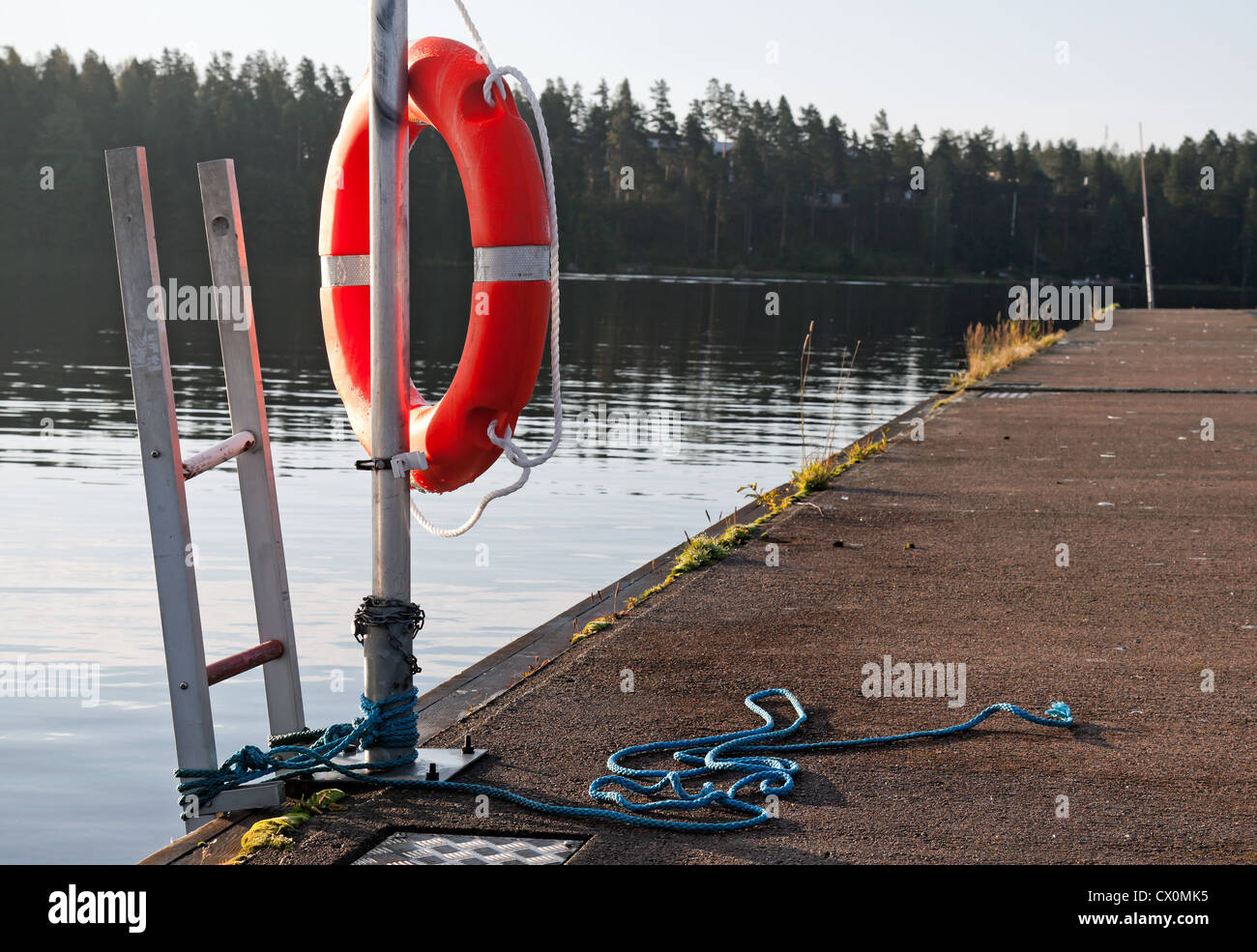 Safety equipment. Bright red lifebuoy on the pier Stock Photo