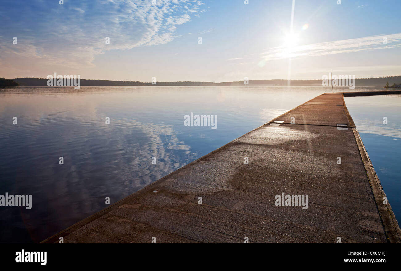 Empty concrete pier in the light of raising sun Stock Photo