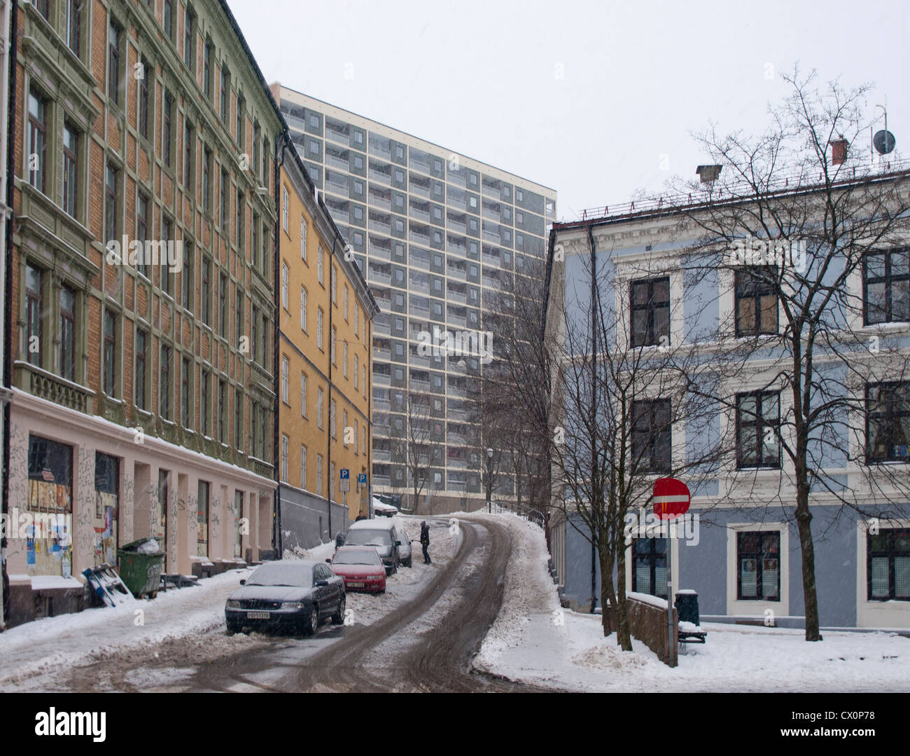 Snowfall in downtown Oslo residential area. Parking and snow clearing do not always agree. Stock Photo