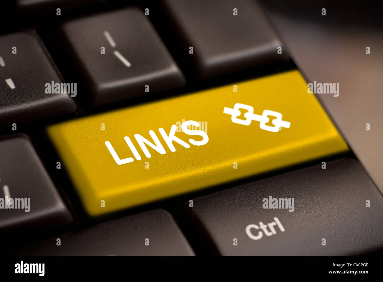 yellow links enter key and silver chain icon. Stock Photo