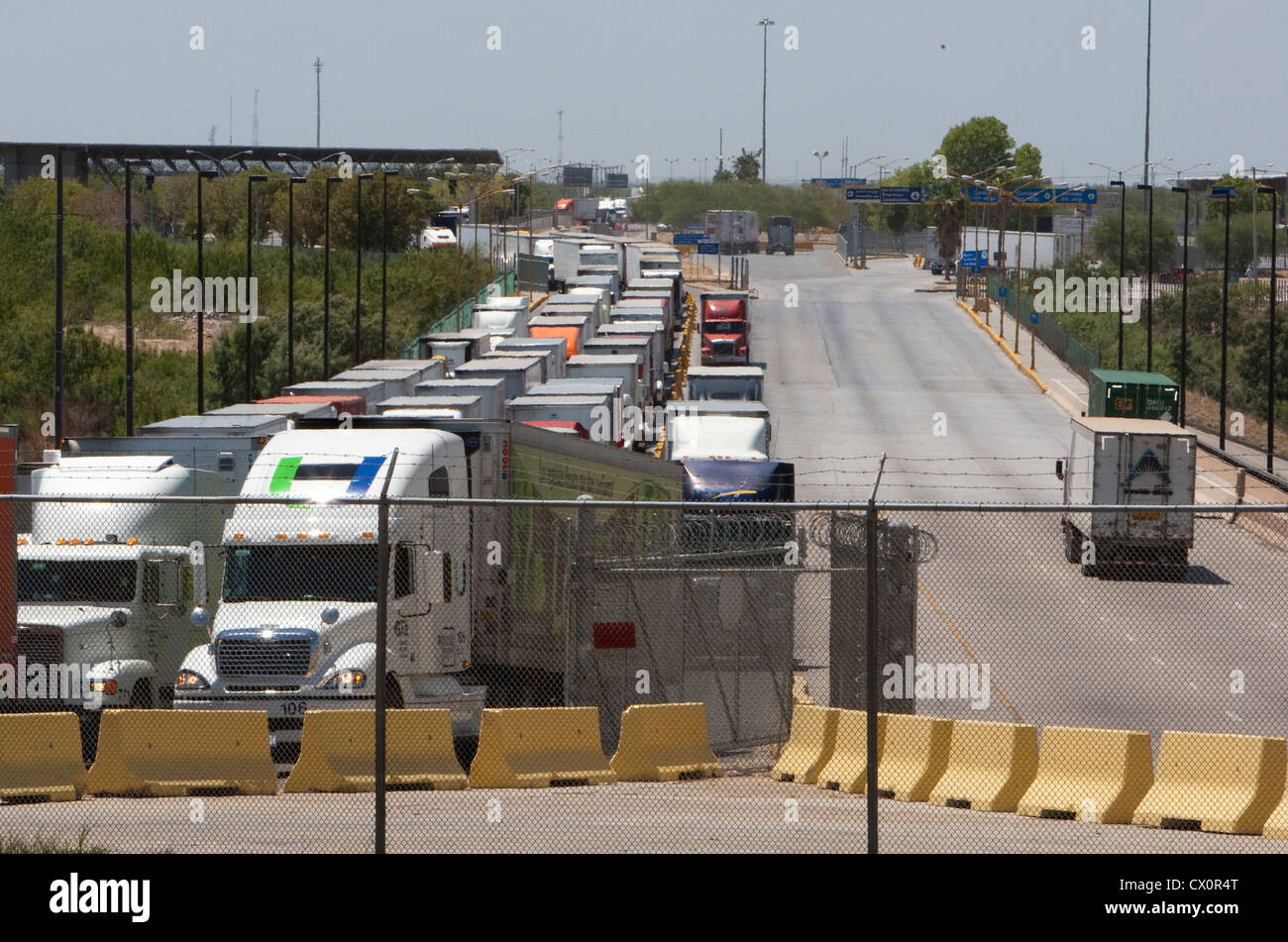 Long line of trucks waiting to enter the US from Mexico at the World Trade International bridge in Laredo Texas Stock Photo