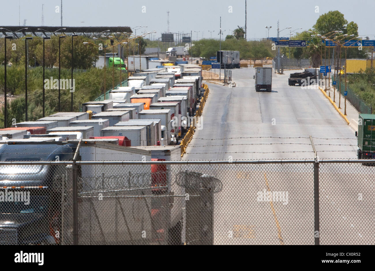 Long line of trucks waiting to enter the US from Mexico at the World Trade International bridge in Laredo Texas Stock Photo