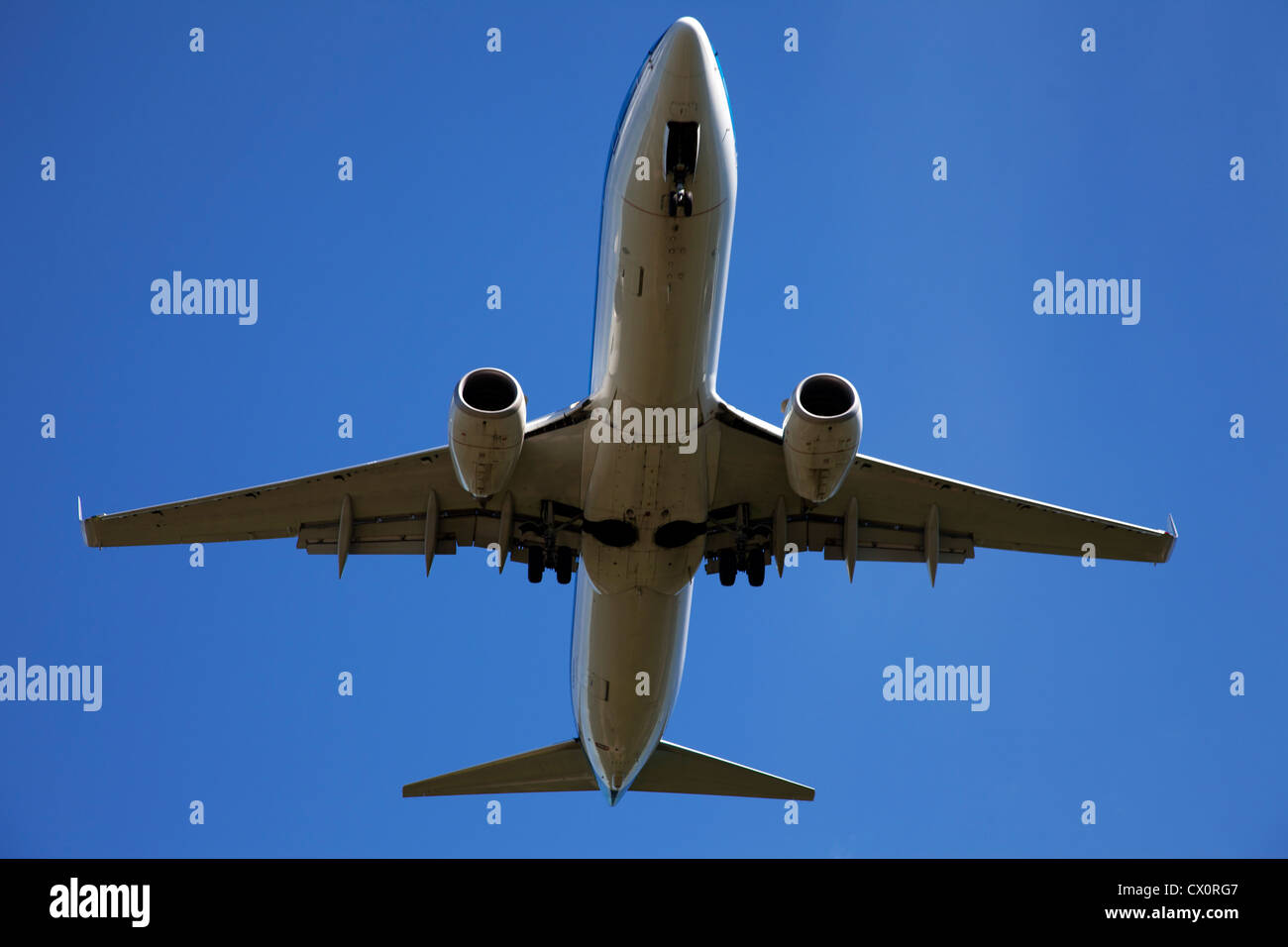 Airplane in the blue sky Stock Photo - Alamy