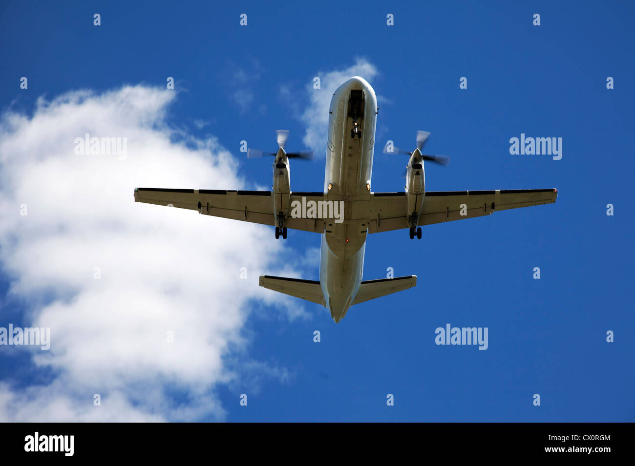 Airplane in the blue sky Stock Photo - Alamy