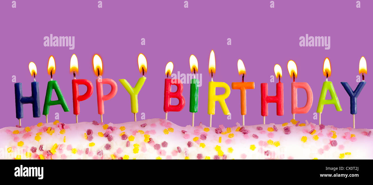 Happy birthday lit candles on purple background Stock Photo - Alamy