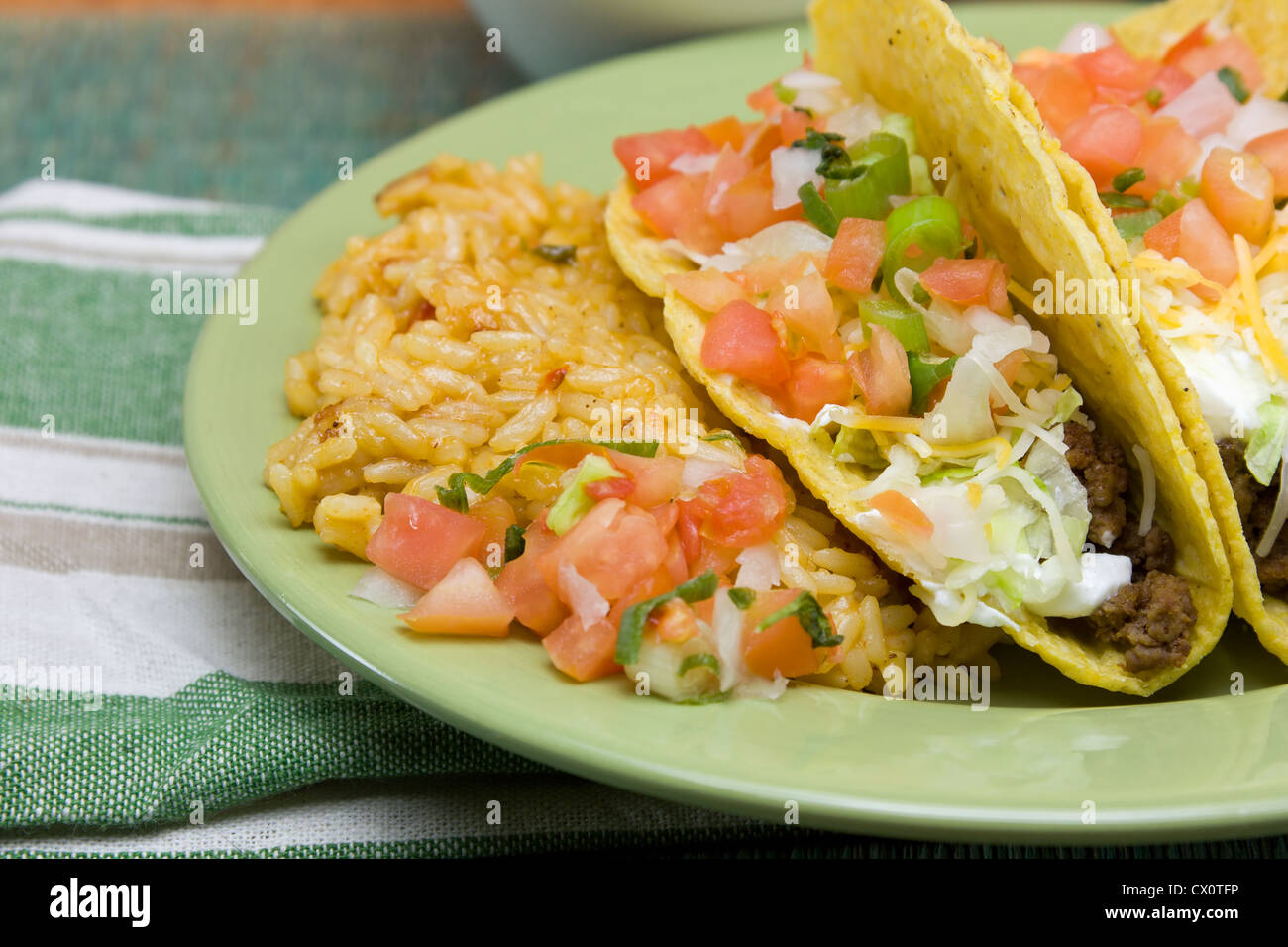 closeup of a taco dinner on a green plate Stock Photo
