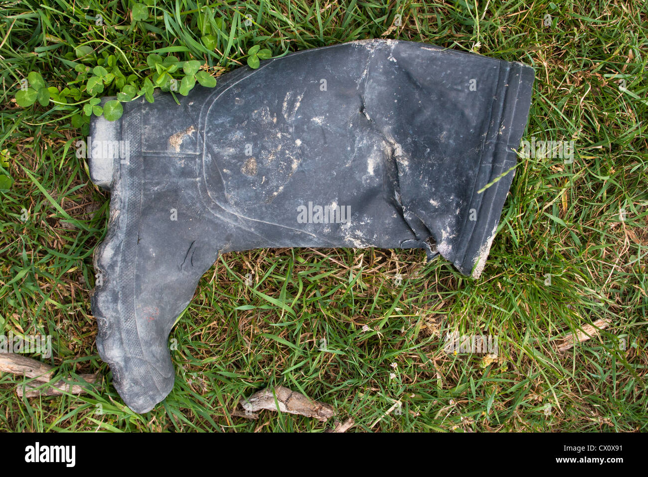 Old fisherman's boot or Fisherman's Old Boot! Found lying in a field beside a river. Stock Photo