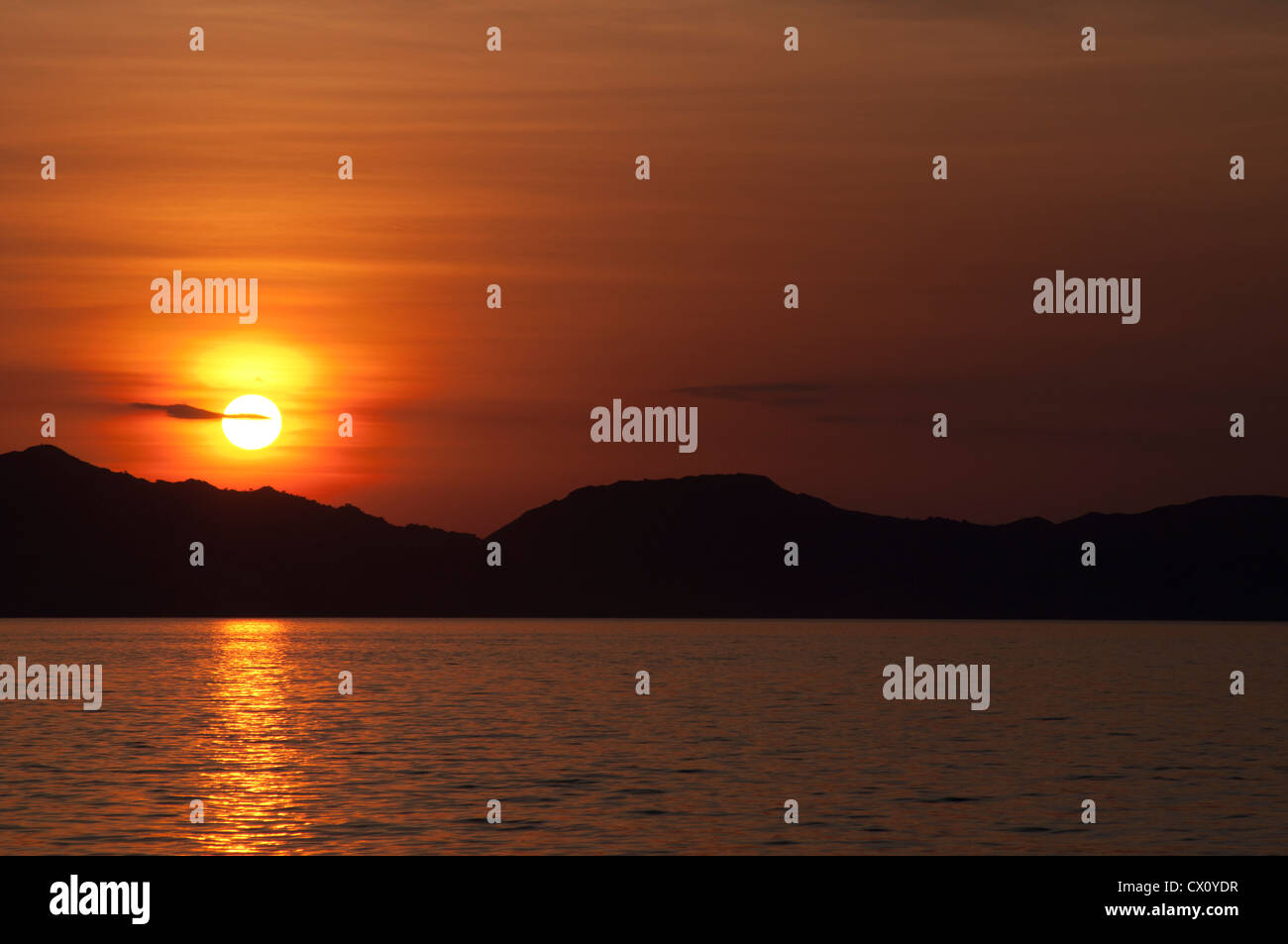 Sunset over the island of Komodo, Komodo National Park, Nusa Tenggara, Indonesia, Pacific Ocean Stock Photo