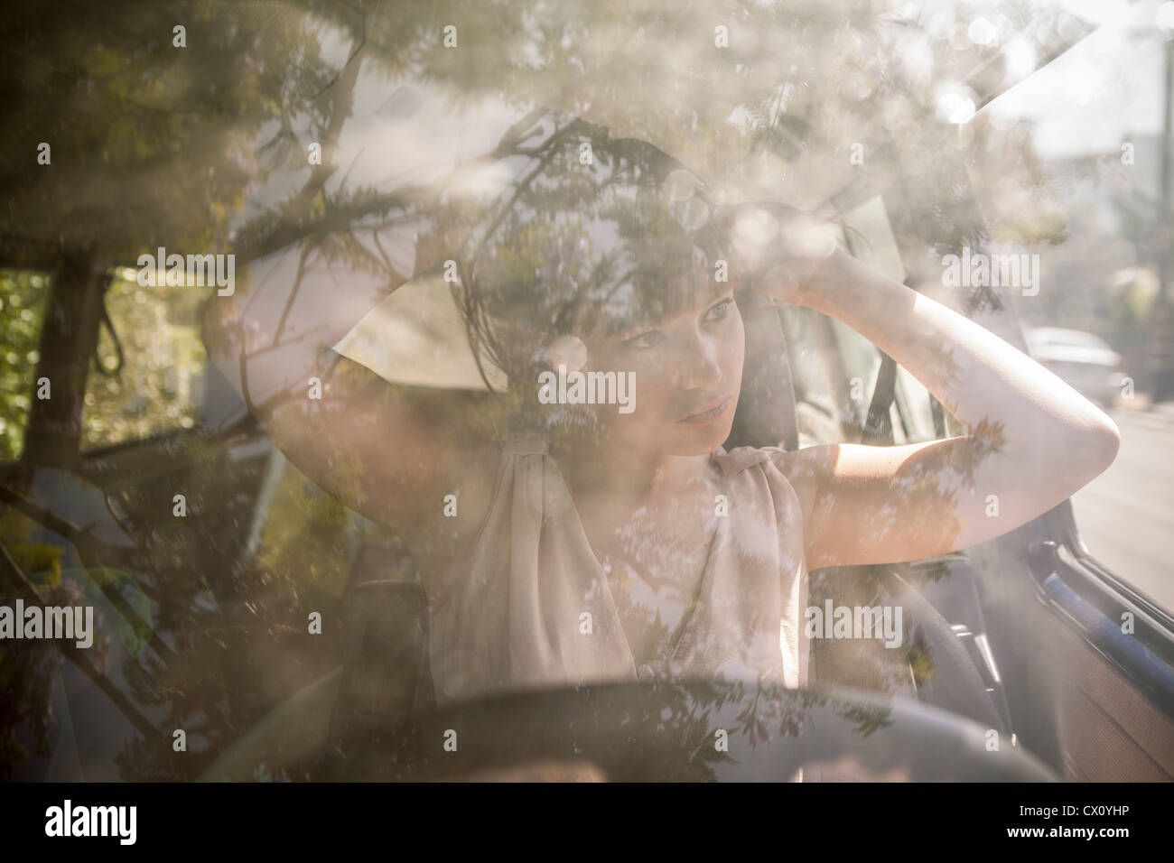 Young woman fixing her hair in a car Stock Photo Alamy