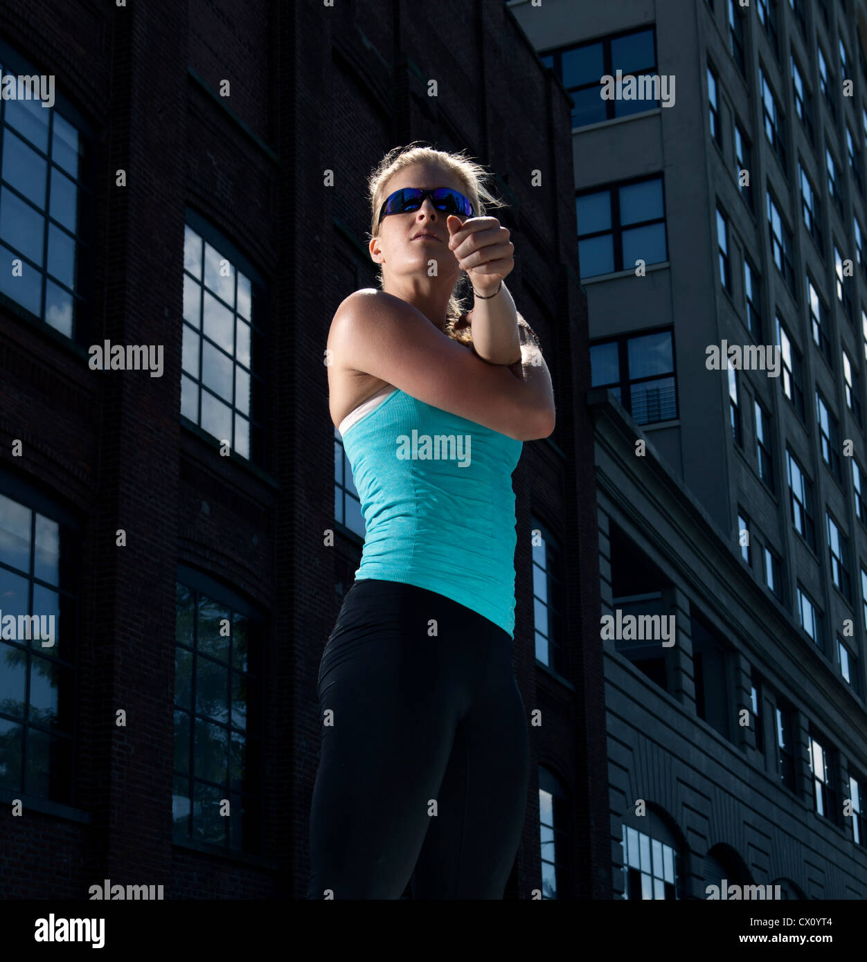 Woman stretching outside office exterior Stock Photo