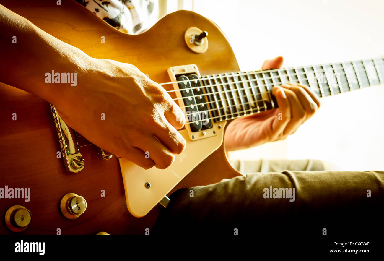 man playing electric guitar with nature light Stock Photo