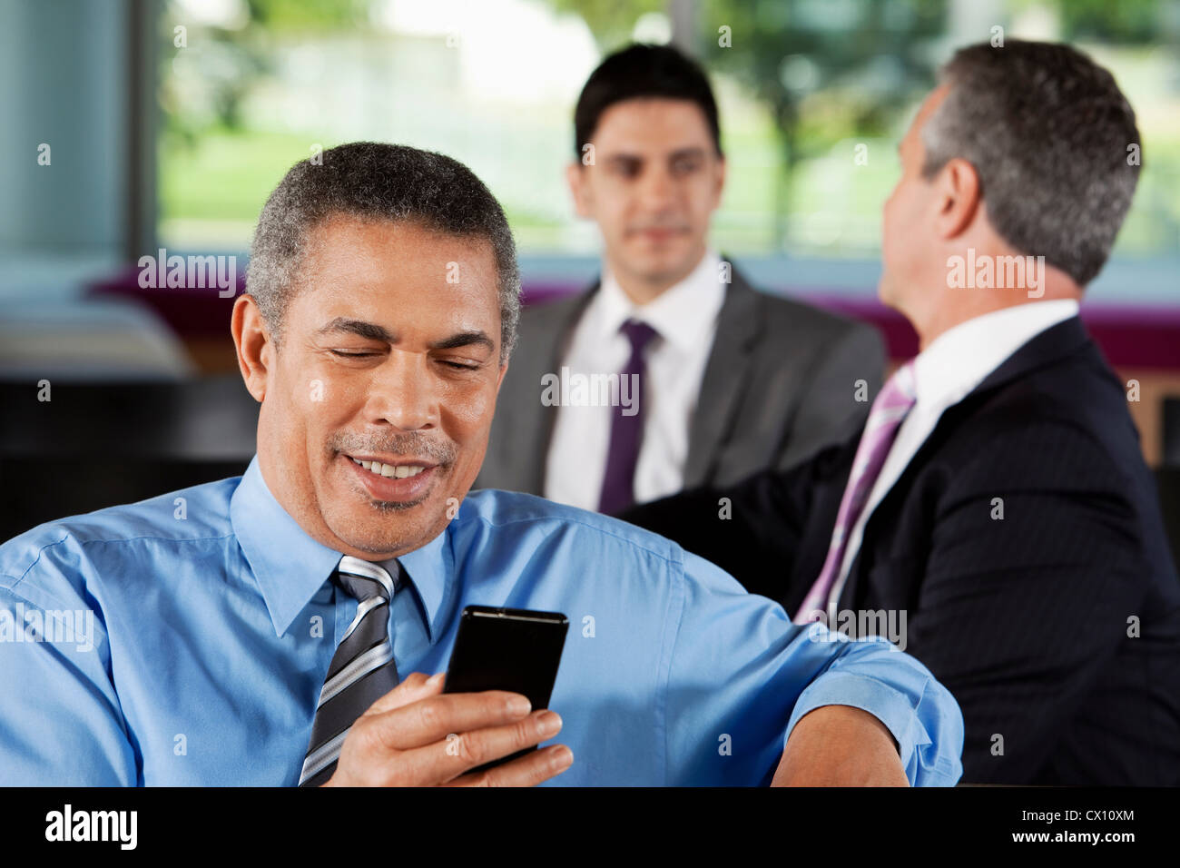 Businessman texting on smartphone Stock Photo