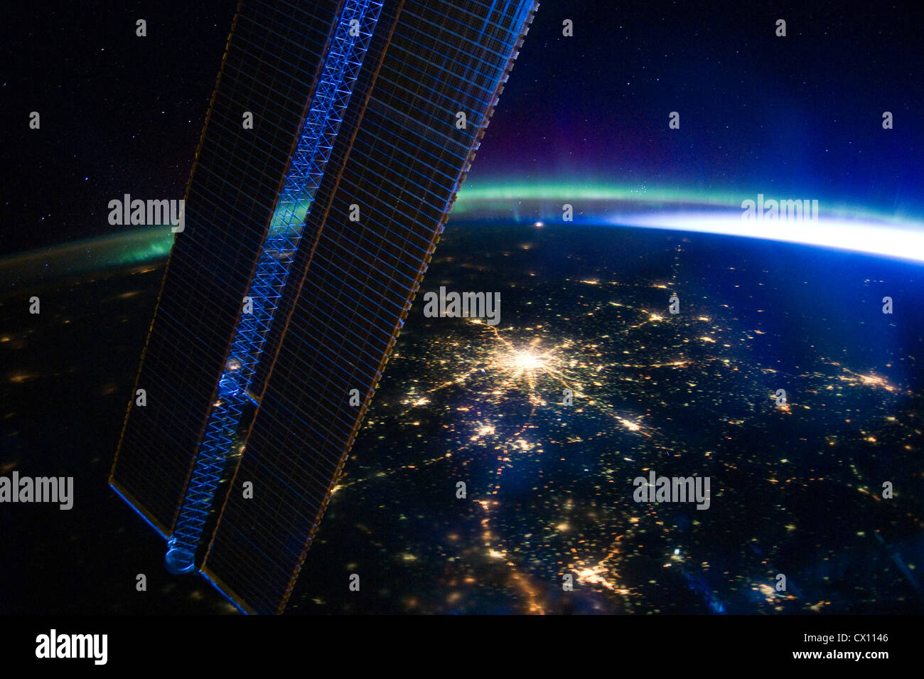 Moscow at nighttime viewed from space with Aurora Borealis visible. Stock Photo