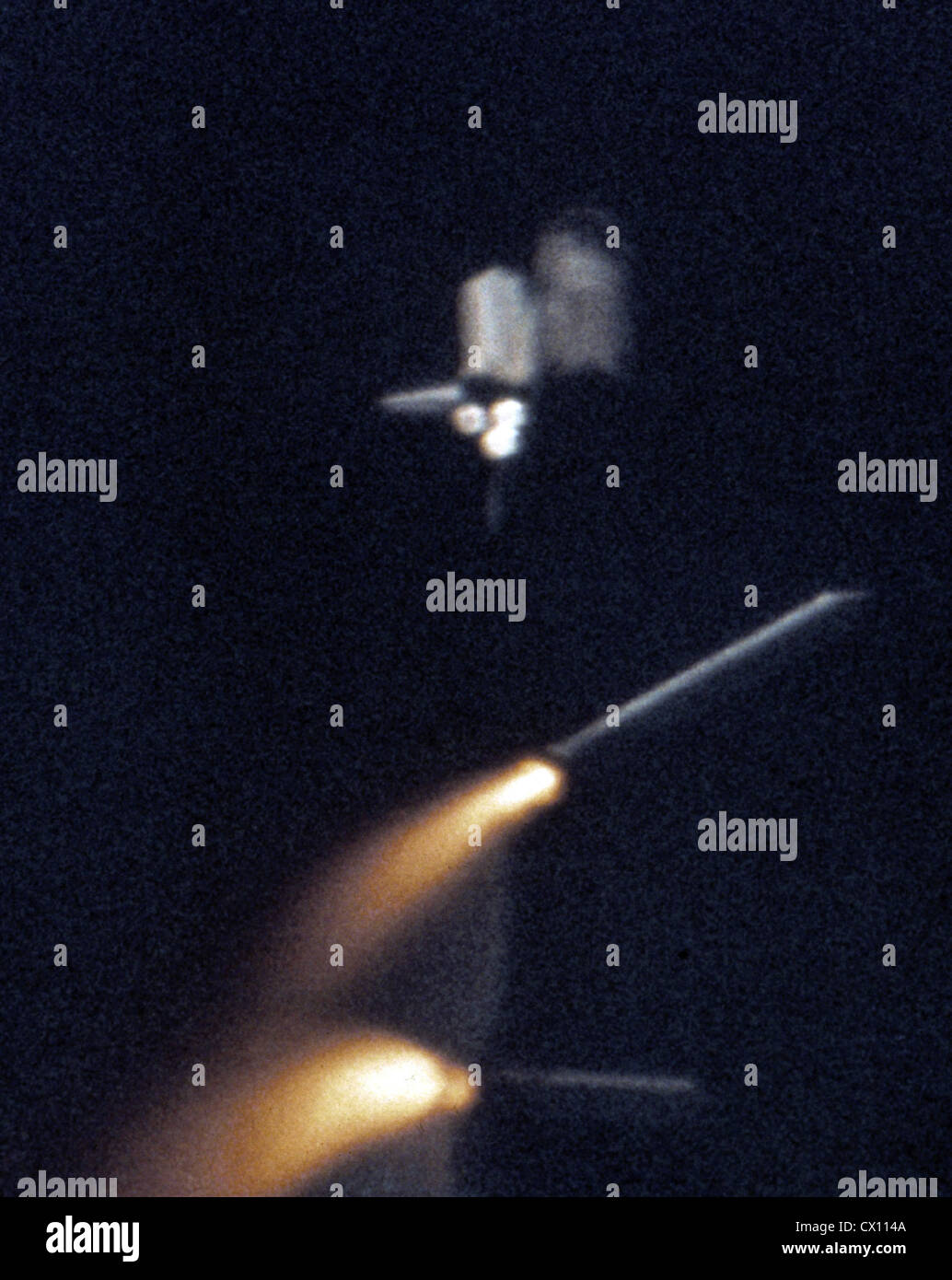 Space shuttle Columbia on the STS-1 mission as two solid rocket boosters are being jettisoned.  Stock Photo