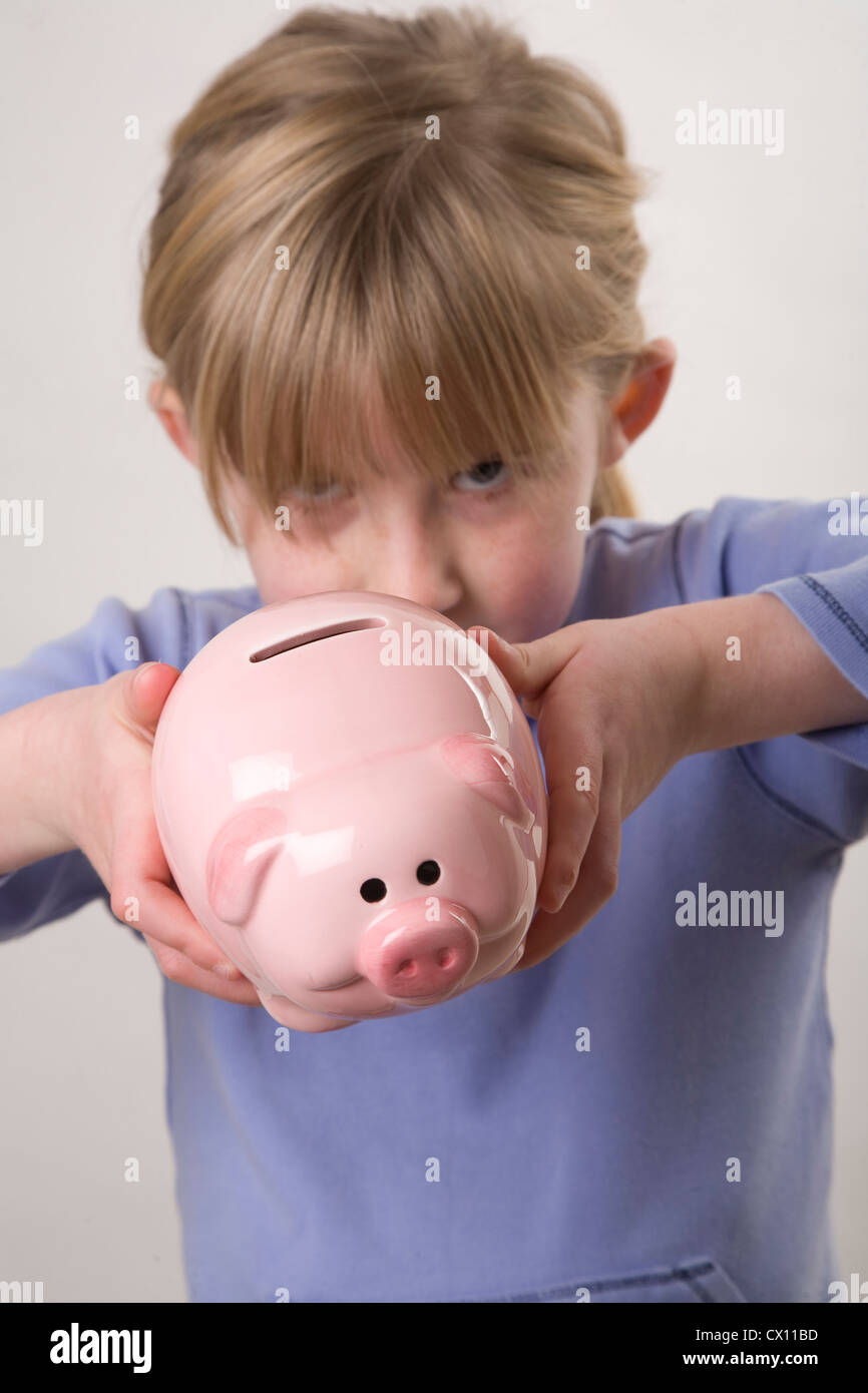 girl holding pink china piggy bank Stock Photo - Alamy