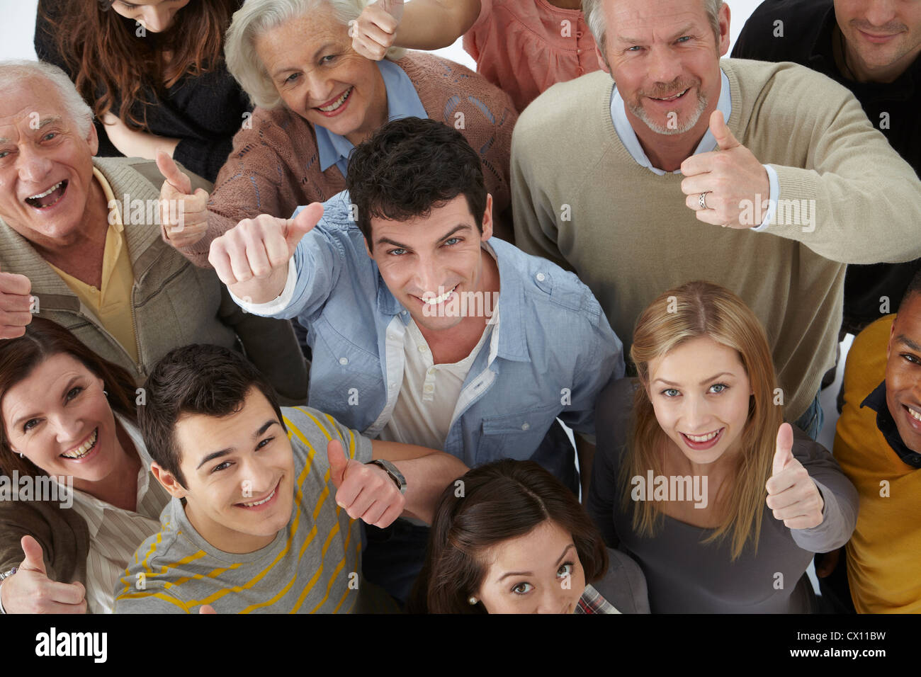 Group of people looking at camera with thumbs up, high angle Stock Photo