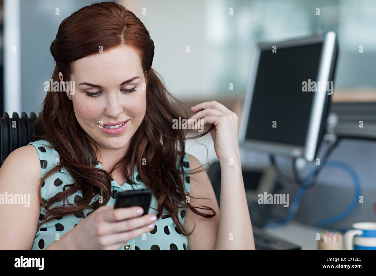 Woman texting on cell phone Stock Photo