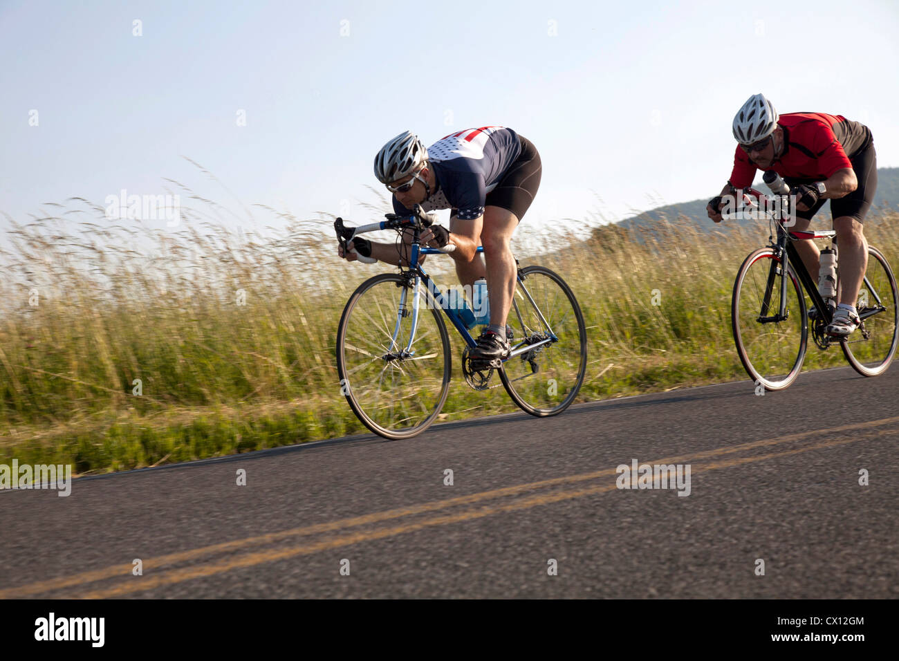 Two cyclists or road, racing downhill Stock Photo