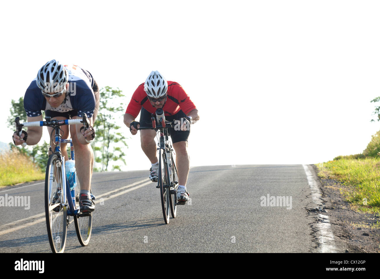 Two cyclists or road, racing downhill Stock Photo