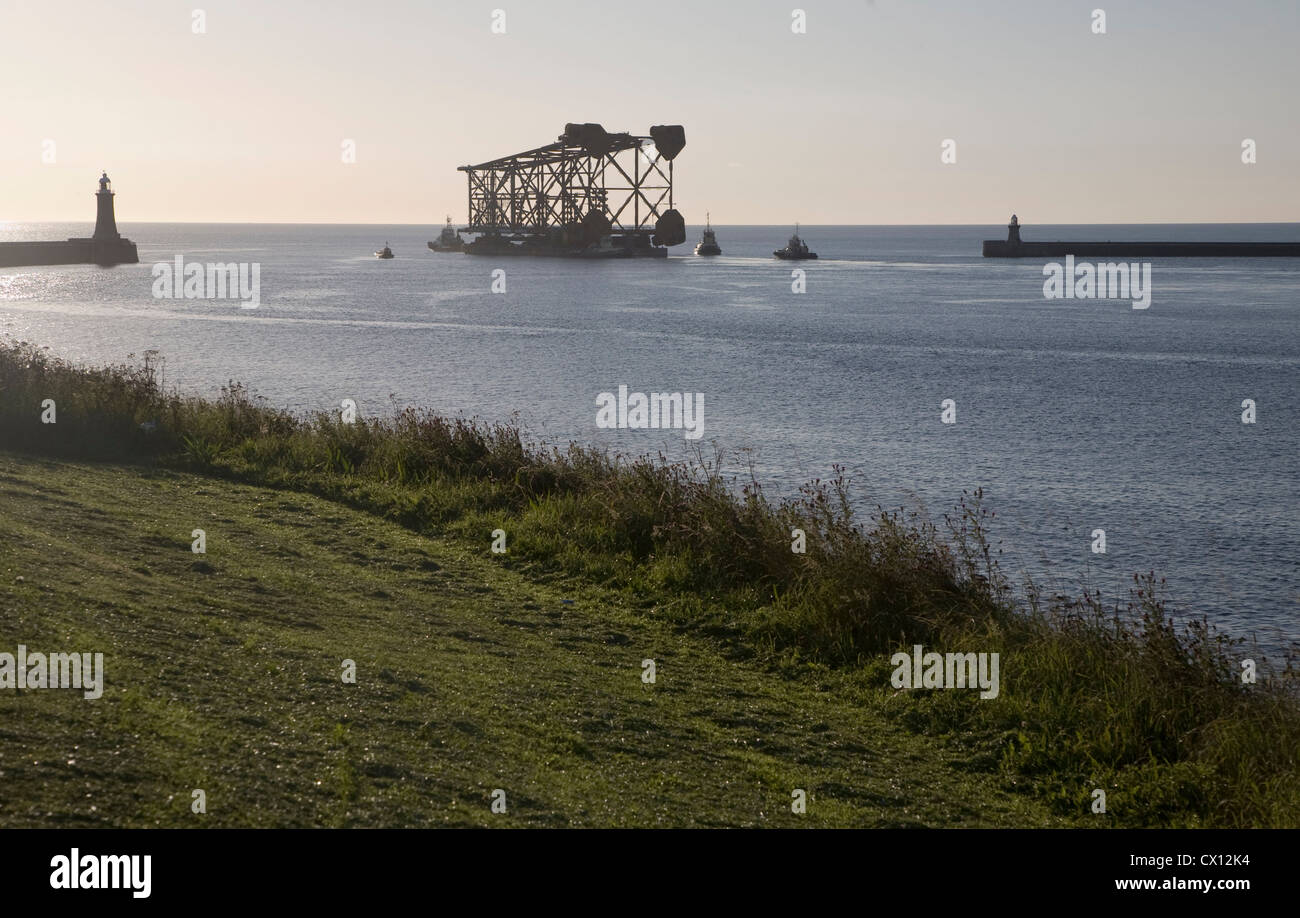 Large Amec oil rig platform base transported from River Tyne into North Sea Tynemouth Northumberland England Stock Photo