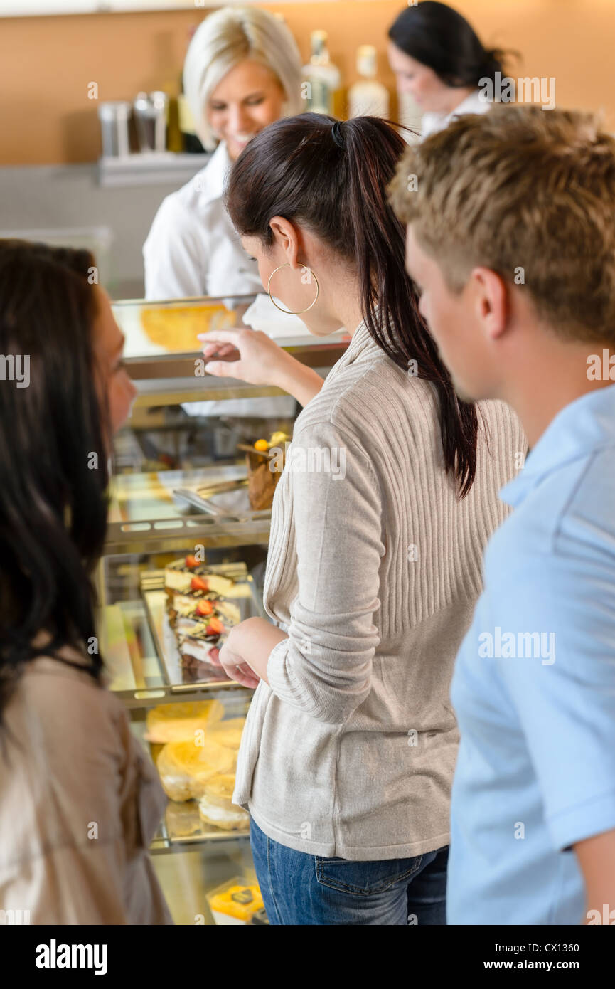 Customers waiting in line to buy dessert woman man cafe Stock Photo