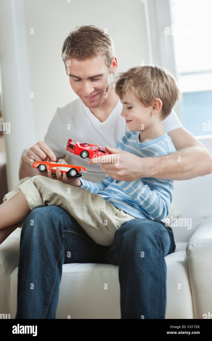 Father and son playing with toy cars Stock Photo