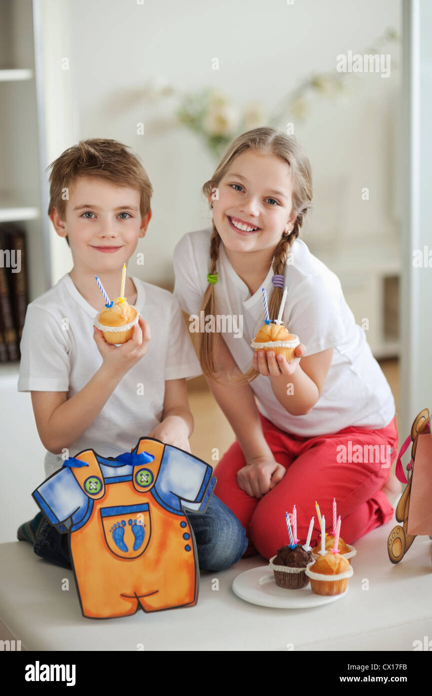 Portrait of little boy and girl with cup cakes Stock Photo