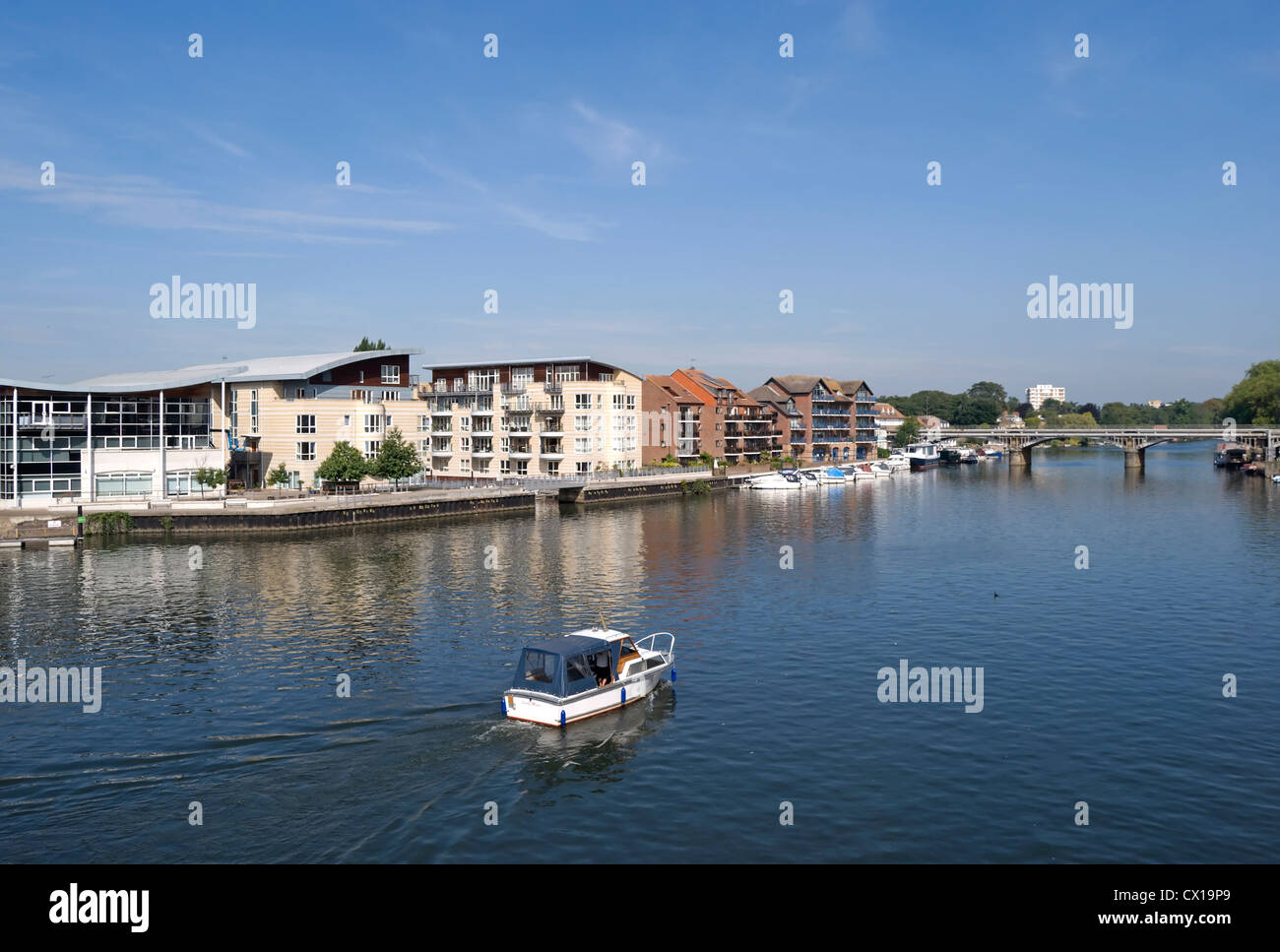 view over river thames from kingston bridge, surrey, england, towards the modern riverside apartments of hampton wick Stock Photo