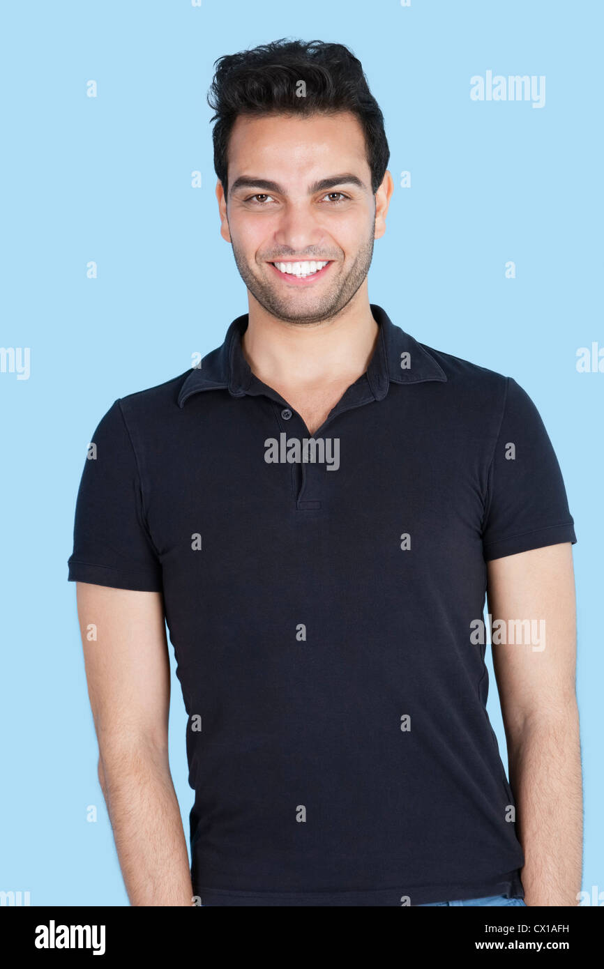 Portrait of a handsome man smiling over blue background Stock Photo