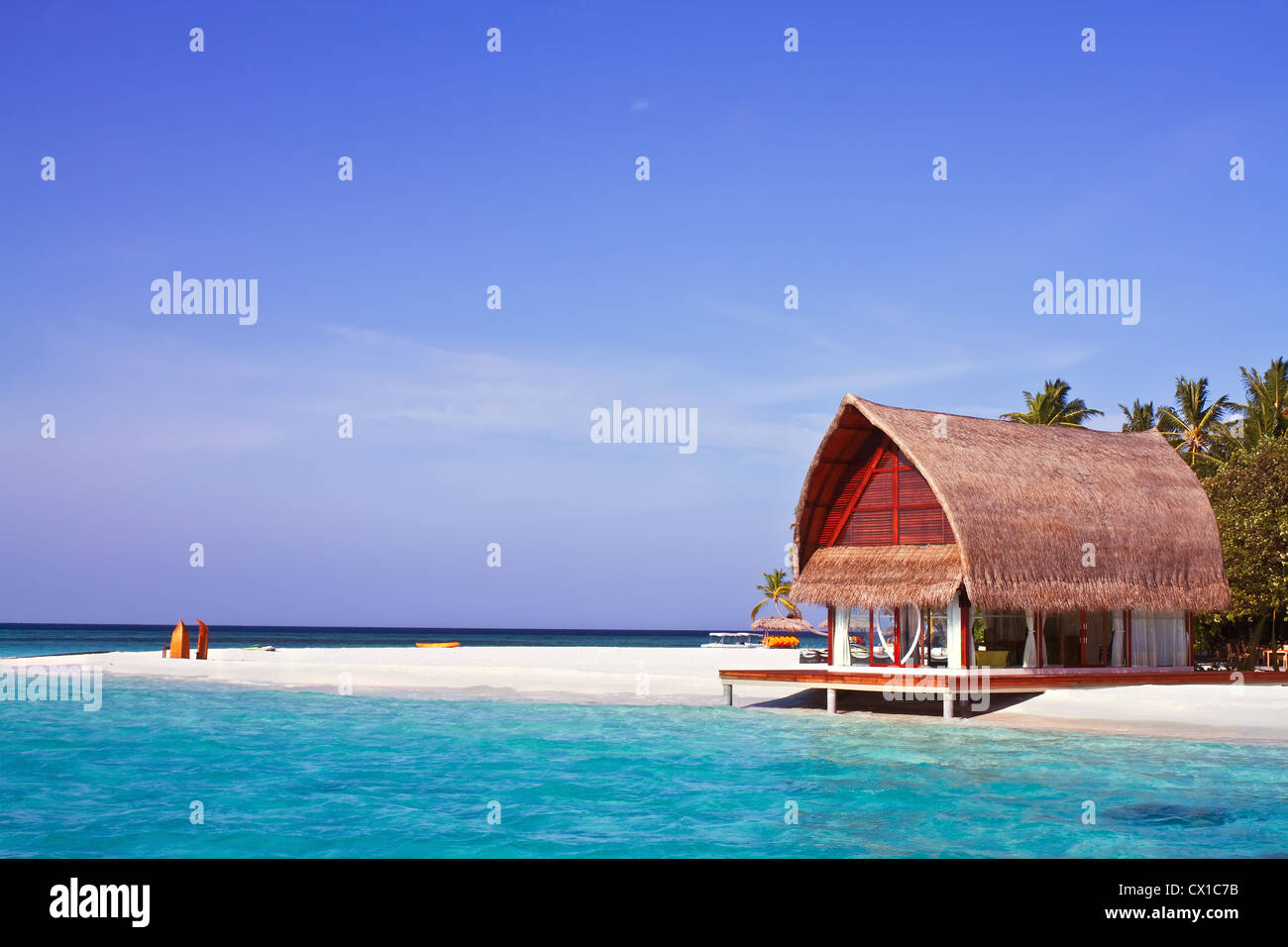 Landscape photo of beach house in Maldive ocean with blue sky Stock Photo