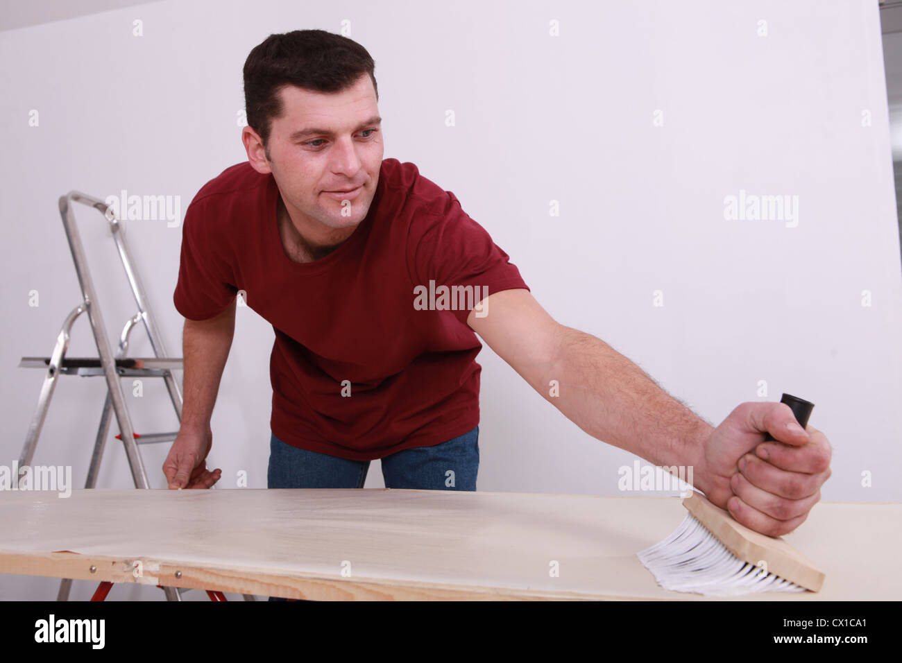 Man gluing paper Stock Photo