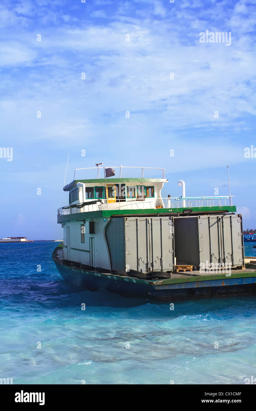 Landscape Photo of Container Ship heading off to the In Ocean Villa of Maldive Stock Photo