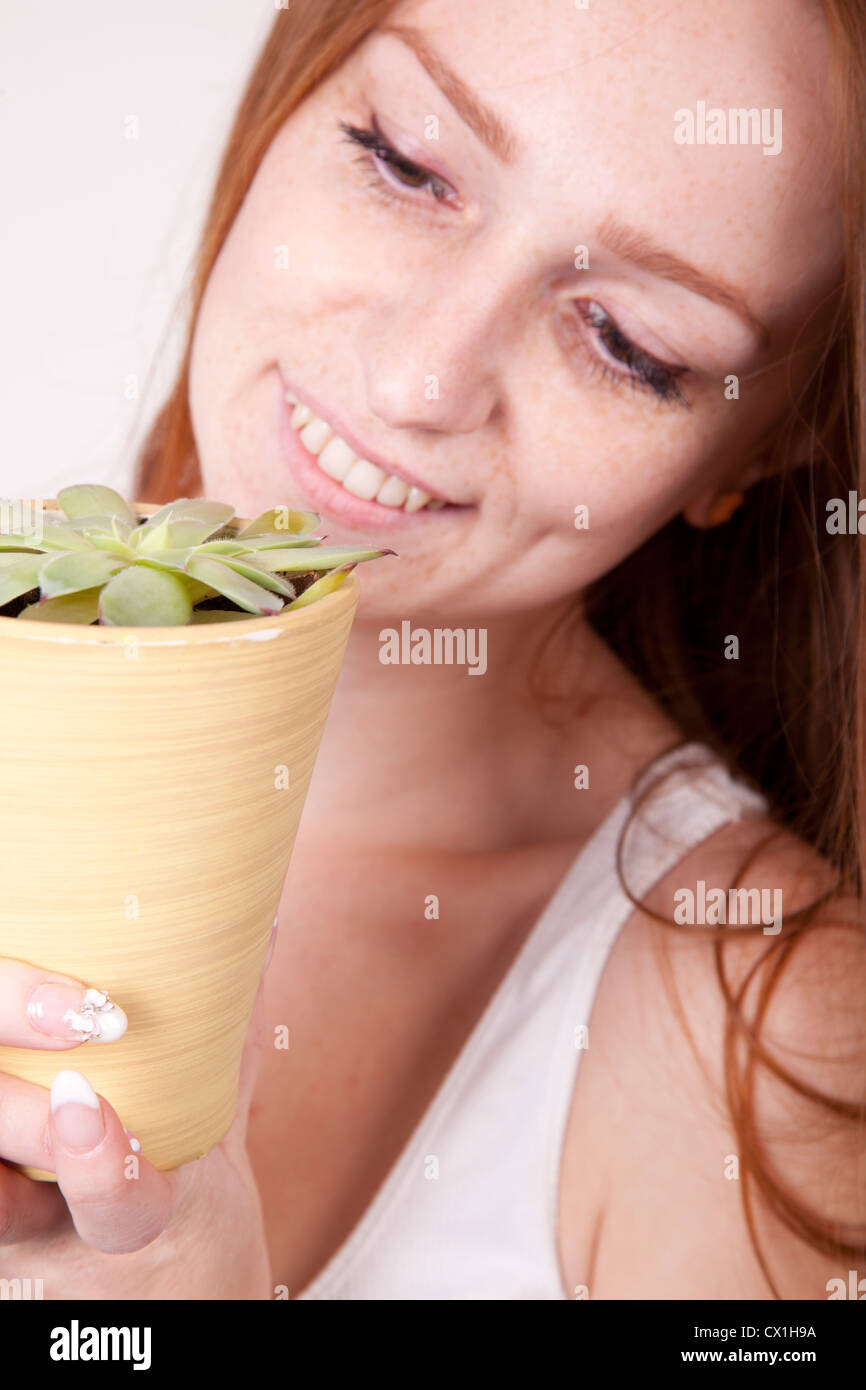 Portrait of a young beautiful girl holding flower Stock Photo - Alamy