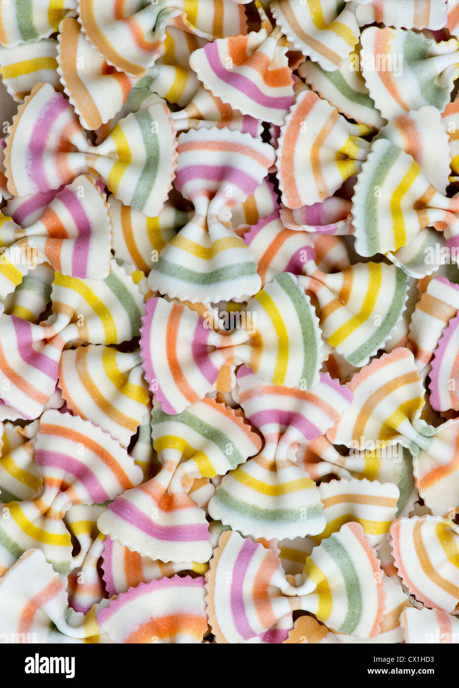 Uncooked Coloured Farfalle Fantasia pasta pattern Stock Photo