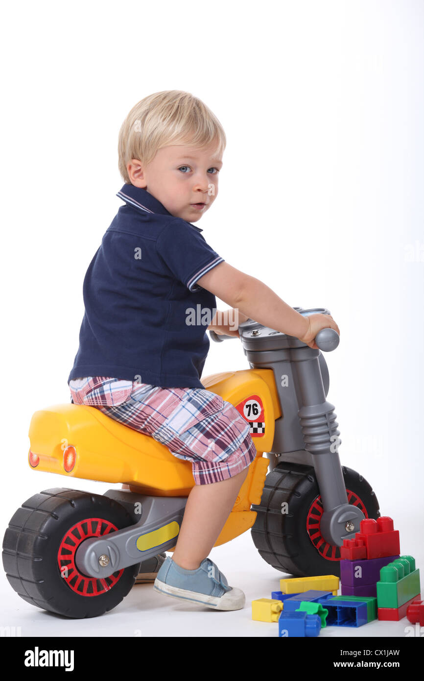 Boy on a toy motorbike Stock Photo Alamy