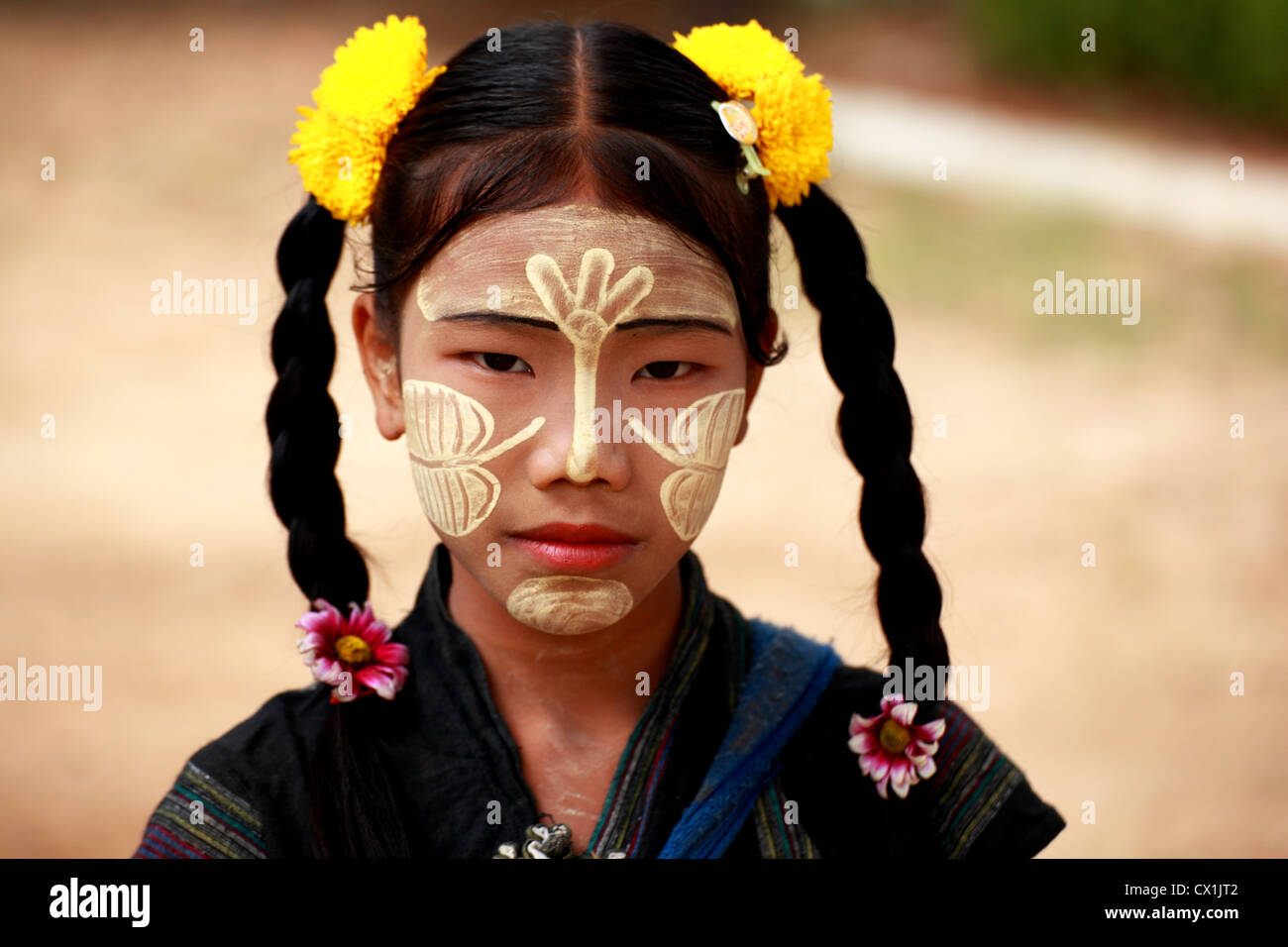 Burmese young girl with a tanaka painted face. This cream from a tree is considered smooth and protect the skin from the sun.Mainly used from females. Stock Photo
